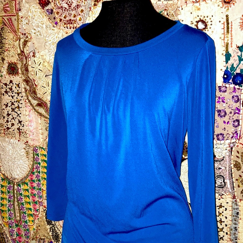 96% Polyester 4% Spandex mid sleeve over head with gold zipper closure